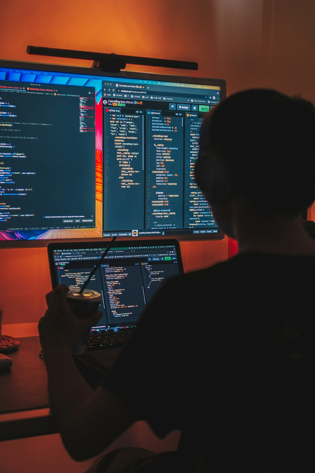 person coding at desk